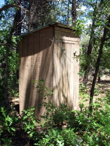 The outhouse still stands, even though there's a flushable toilet inside